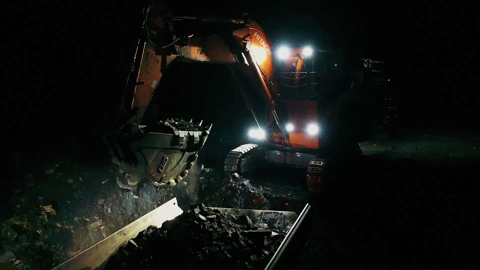 MacKay excavator working under lights at night
