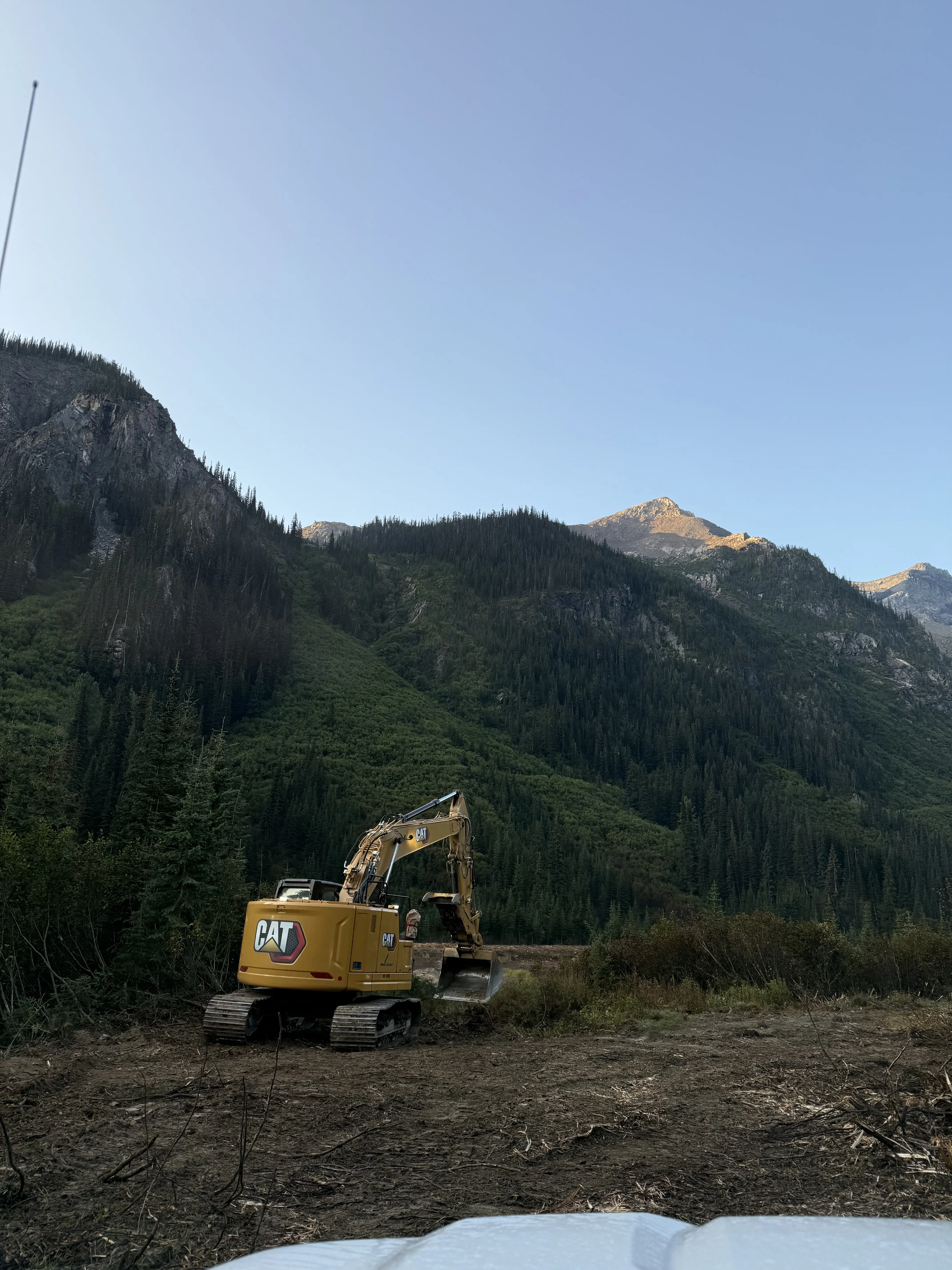 Excavator placing material during a creek restoration