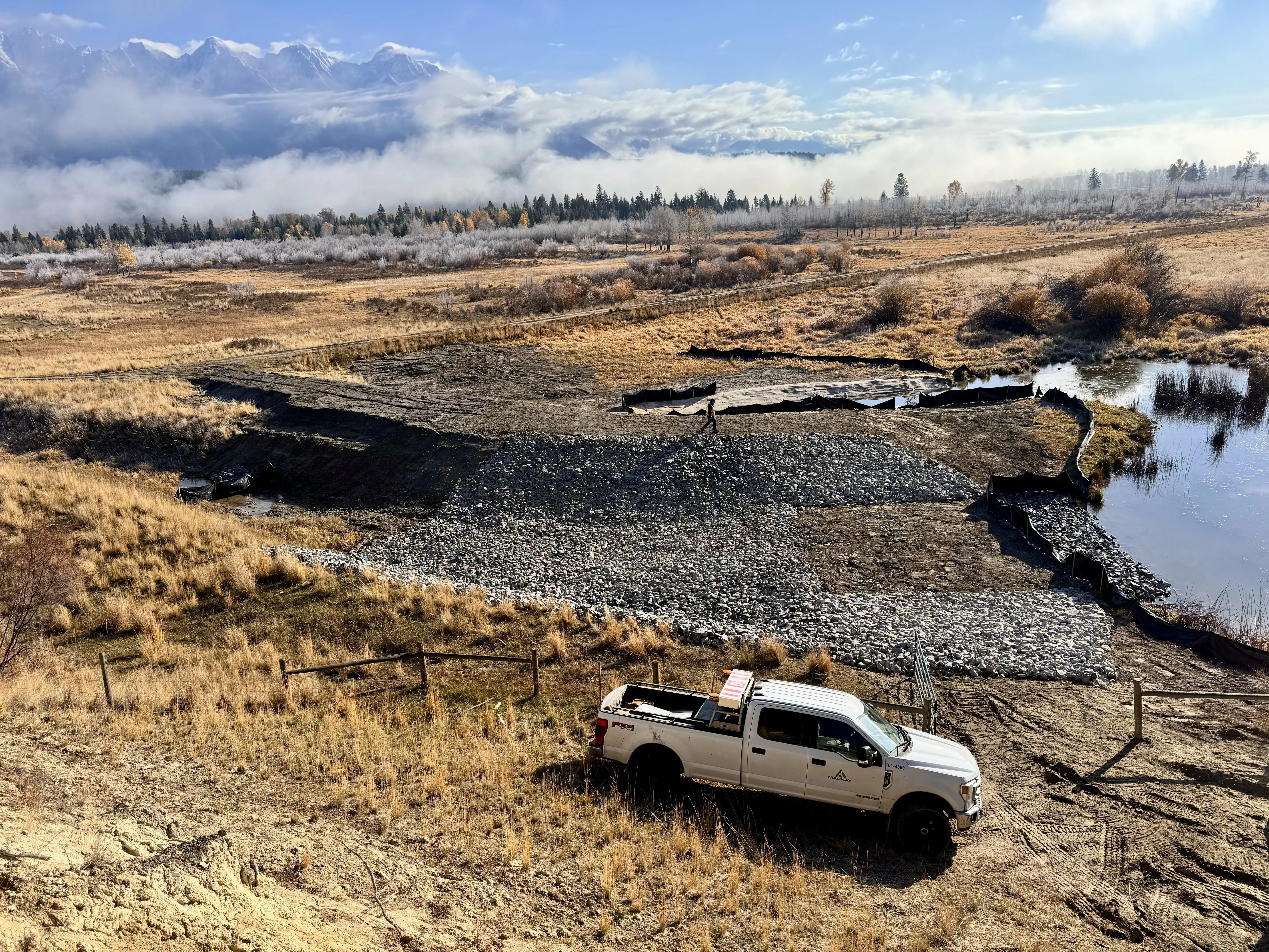 Aerial view of a riparian restoration site winding through a valley floor